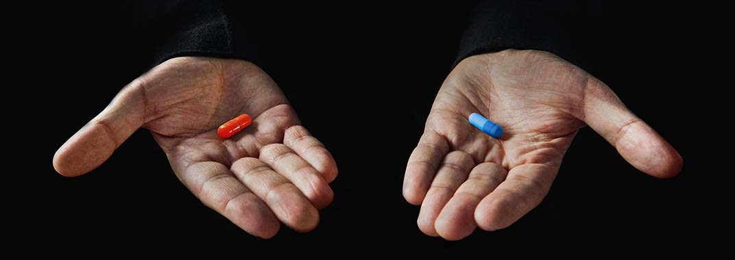 Hands with red and blue pill